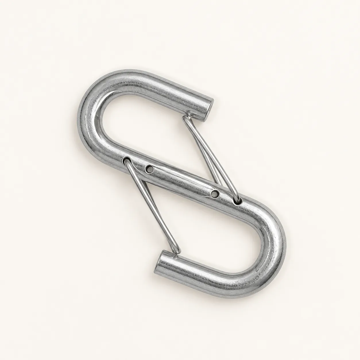 Top-down view of the linked wire-gate hooks on an off-white background